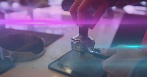 Barista tamping coffee grounds with tamper in vibrant cafe setting