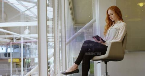 Businesswoman Engaging with Technology in Modern Atrium