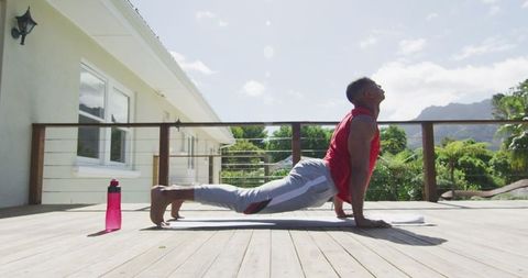 Focused Man Practicing Yoga on Outdoor Terrace