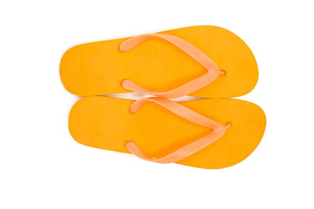 Pair of yellow beach flip flop slipper on white background