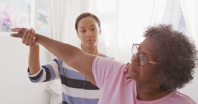 Nurse Assisting Senior Woman in Physical Therapy Session at Home - Download Free Stock Images Pikwizard.com