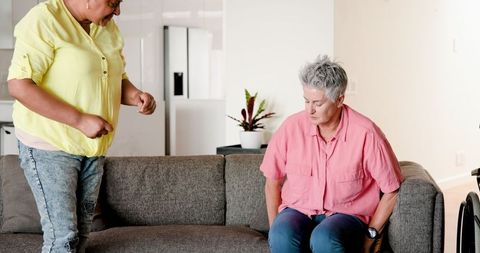 Senior Lesbian Couple Conversing at Home on Couch