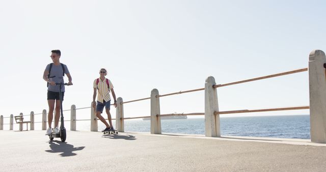 Young Friends Riding Electric Scooters By Ocean Promenade - Download Free Stock Images Pikwizard.com