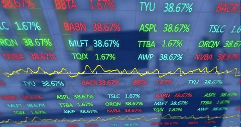 Glowing stock market data and interactive graphs in office