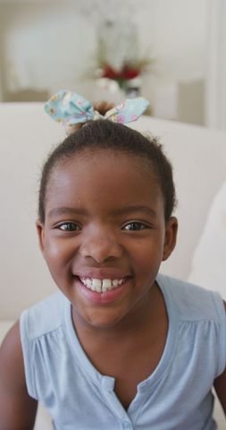 Joyful african american girl laughing indoors