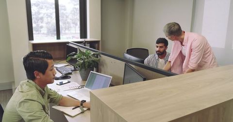 Diverse Corporate Team Collaborating at Office Desks
