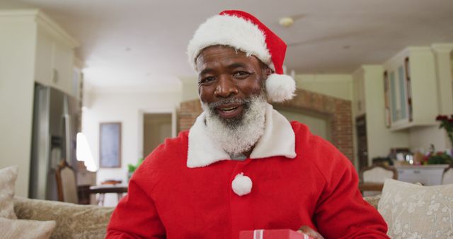 Smiling African American Santa Claus Giving Gift Indoors - Download Free Stock Images Pikwizard.com