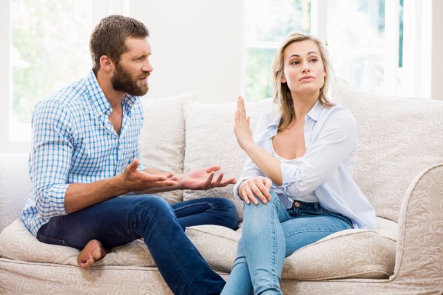 Upset couple arguing with each other at home