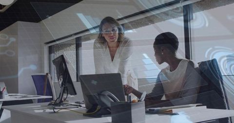 Collaboration Between Two Businesswomen in Modern Office Setting