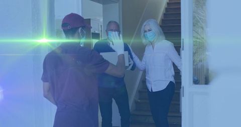 Package delivery to senior couple with lens flare effect