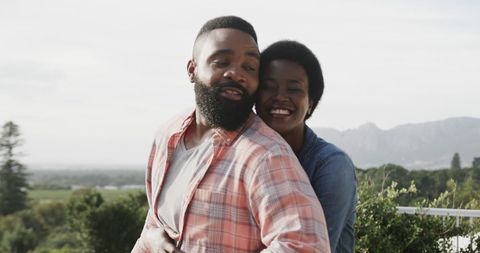 Joyful African American Couple Embracing on Sunny Balcony