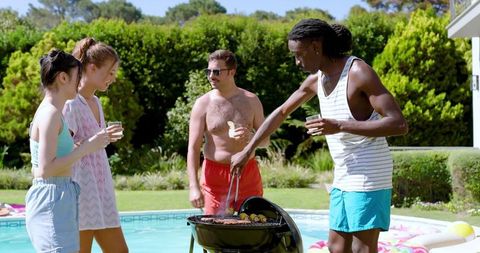 Friends Grilling Burgers by Poolside in Summer Gathering