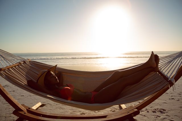 Woman sleeping in a hammock on the beach - Download Free Stock Photos Pikwizard.com