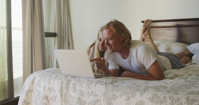 Young Couple Relaxing Together on Bed Using Laptop - Download Free Stock Images Pikwizard.com