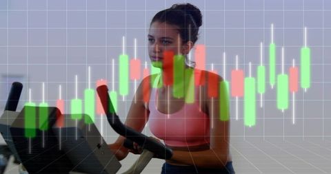 Indoor spin workout with candlestick chart overlay blending fitness training and data
