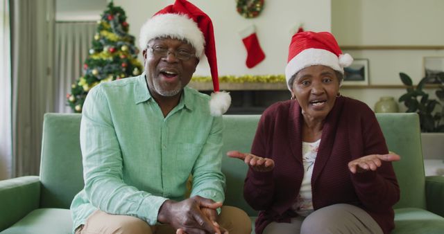 Happy african american senior couple in santa hats on image call at christmas time - Download Free Stock Photos Pikwizard.com