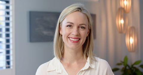 Smiling Woman in Elegant Interior Setting