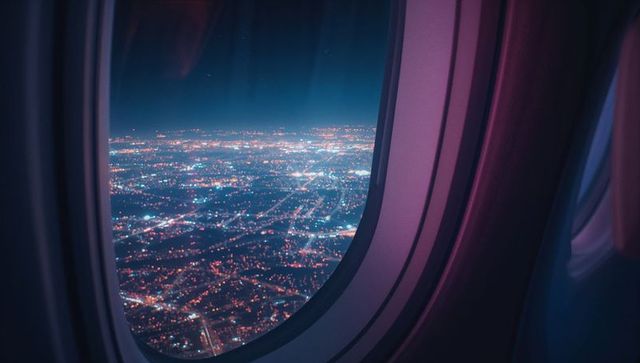 City lights viewed from airplane window at night