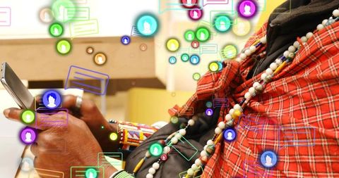 Tapping smartphone while wearing red plaid and beaded necklaces with floating chat icons