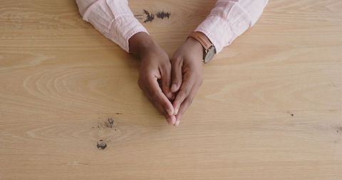 Expressive hands at wooden desk: professional gestures of motivation