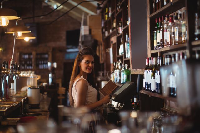 Portrait of female bar tender holding menu in pub