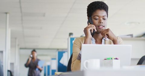 Businesswoman Multitasking with Laptop and Phone in Office - Download Free Stock Images Pikwizard.com