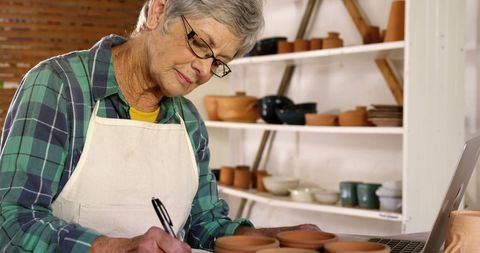Senior Female Artist Documenting Pottery Creations in Studio - Download Free Stock Images Pikwizard.com