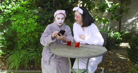 Mother and Daughter Bonding with Skincare and Tea in Garden