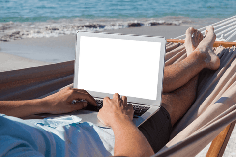 Man Enjoying Coastal Relaxation While Using Laptop on Hammock - Download Free Stock Videos Pikwizard.com