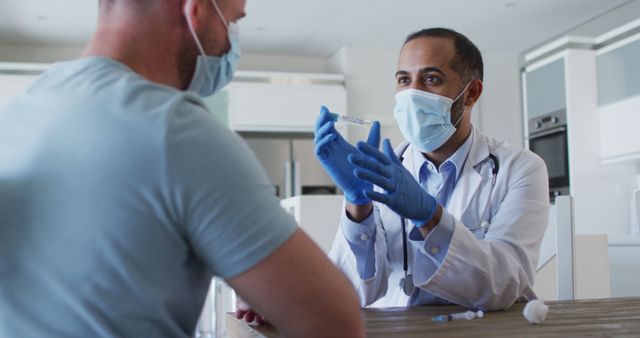 Doctor in medical mask discussing syringe with patient at clinic - Download Free Stock Images Pikwizard.com