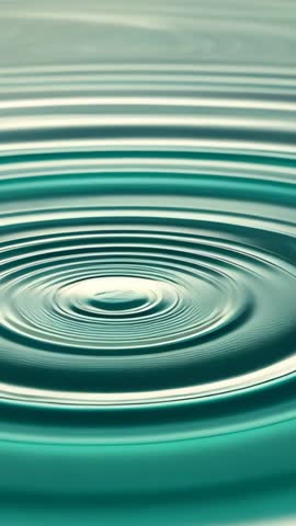 Droplet Creating Concentric Ripples in Teal Water Vertical Loop for Relaxation