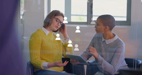Business Professionals Using Digital Tablet in Collaborative Meeting