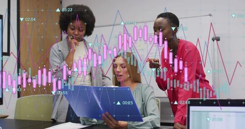 Diverse Businesswomen Collaborate on Financial Data Analysis in Modern Office
