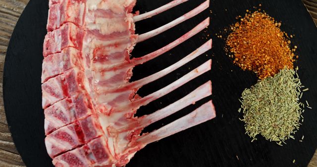 Raw Rack of Lamb with Spices on Dark Wooden Surface - Download Free Stock Images Pikwizard.com