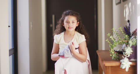 Young Girl Smiling While Walking in Hallway at Home