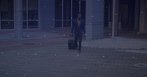 Business traveler with suitcase walking in urban plaza