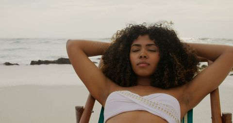 Woman Relaxing on Sun Lounger by Tranquil Ocean - Download Free Stock Images Pikwizard.com