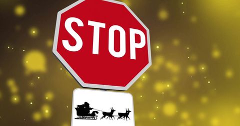 Festive stop sign with flying santa silhouette