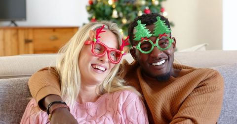 Cheerful Couple Celebrating Christmas with Festive Accessories