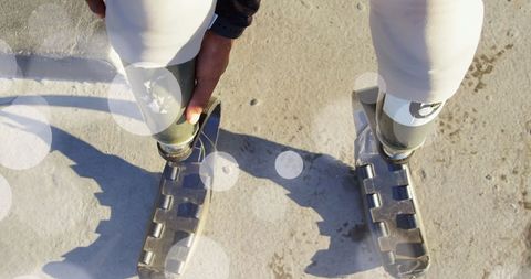 Inspirational athlete with prosthetic legs on sunny day