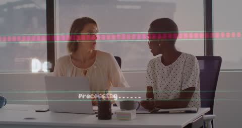 Diverse Business Women Utilizing Digital Data Interfaces in Office