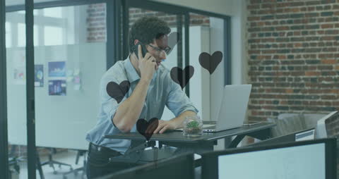 Businessman Communicating in Modern Office with Floating Hearts