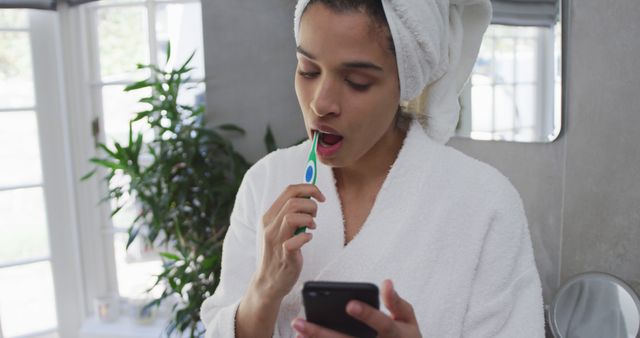 Woman Brushing Teeth and Using Smartphone in Bathroom - Download Free Stock Images Pikwizard.com