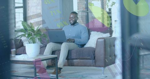 Financial analyst monitoring data on laptop in modern office