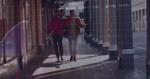 Image shows diverse people walking along a city street with financial graphs and data overlayed. Suitable for illustrating concepts of global finance, modern urban lifestyles, and data analytics in magazines, websites, and educational materials discussing economy and technology.