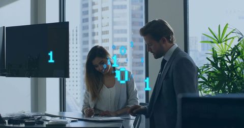 Diverse Professionals Engaged in Digital Data Processing in Modern Office