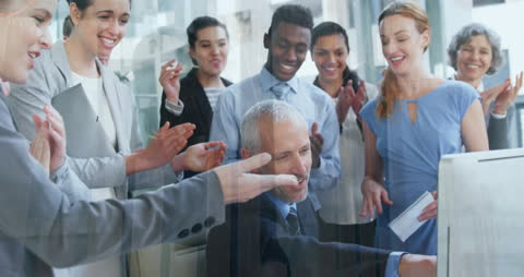 Diverse Team Celebrating Success in Office Meeting