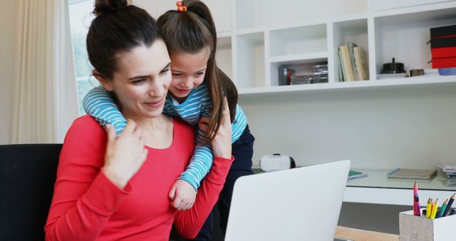 Mother and Daughter Smiling While Using Laptop at Home Office - Download Free Stock Images Pikwizard.com