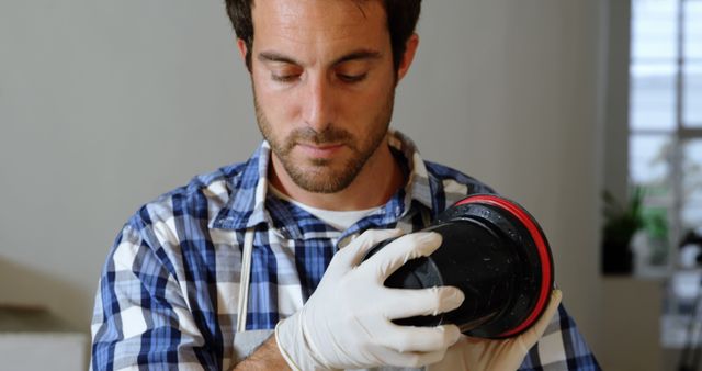 Focused Photographer Cleaning Camera Lens with Gloves - Download Free Stock Images Pikwizard.com