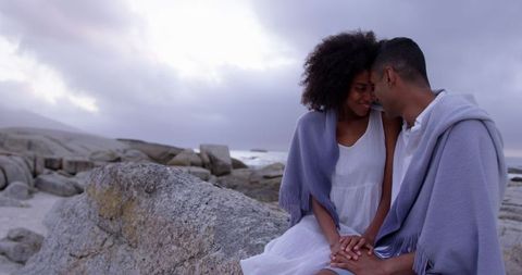 Romantic Couple Embracing on Tranquil Beach at Sunset